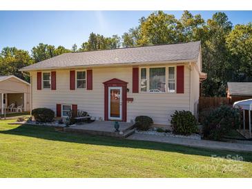 Charming two-story home with light yellow siding, red shutters, and a well-manicured lawn at 1501 Fern Forest Dr, Gastonia, NC 28054