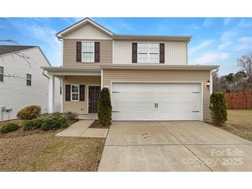 Charming two-story home featuring a two-car garage and neutral siding and inviting curb appeal at 3113 Ellingford Rd, Charlotte, NC 28214