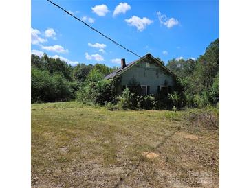 Overgrown exterior view of home featuring a yard and a traditional style at 4724 Pottery Rd, Catawba, SC 29704