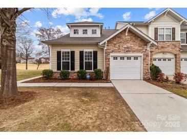 Charming home exterior with a stone accent wall and a two-car garage at 8412 Brookings Dr, Charlotte, NC 28269