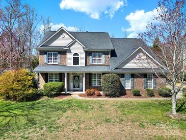 Charming two-story brick home with manicured lawn and mature landscaping at 11000 King George Ln, Waxhaw, NC 28173