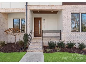 Welcoming front entrance with brick steps and modern door, complemented by a neatly landscaped yard at 5520 Chedworth Dr, Charlotte, NC 28210
