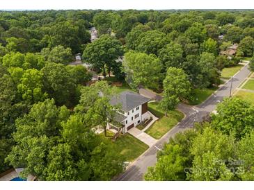 Stunning aerial view of a two-story home nestled among lush greenery in a serene neighborhood at 5610 Farmbrook Dr, Charlotte, NC 28210