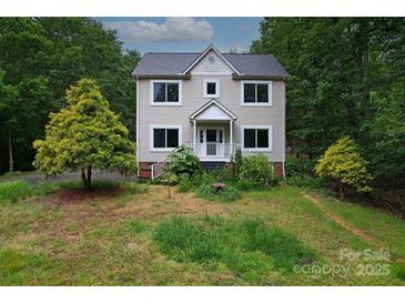 Charming two-story home featuring large windows and a welcoming front porch at 946 Laurelwood Dr, Clover, SC 29710