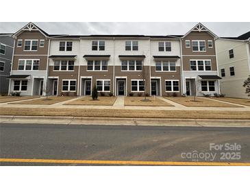 A row of attractive two-story townhomes featuring a combination of light and dark siding and well-manicured lawns at 225 Kennerly Ave # A, Mooresville, NC 28115