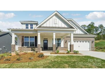 Inviting exterior with covered porch, brick accents, and two-car garage enhance this charming home at 237 Miramar Dr, York, SC 29745