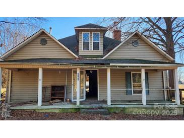 Exterior view of a two-story house with a front porch, showcasing its architectural style and outdoor space at 3181 N Olivers Cross Rd, Newton, NC 28658