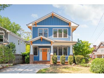 Charming two-story home with blue siding, white trim, an orange door, and well-maintained landscaping at 331 Solomon St, Charlotte, NC 28216
