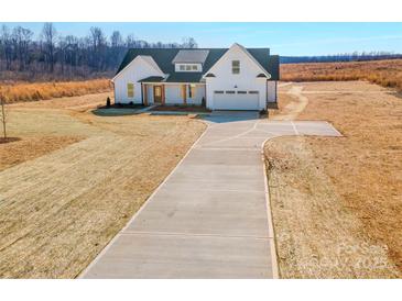 New construction, white farmhouse-style home featuring a large lot and a concrete driveway at 520 Shoal Rd, Lincolnton, NC 28092