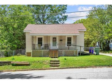 Charming single-story home featuring a cozy front porch, well-maintained lawn, and a welcoming facade at 225 Institute St, Mooresville, NC 28115