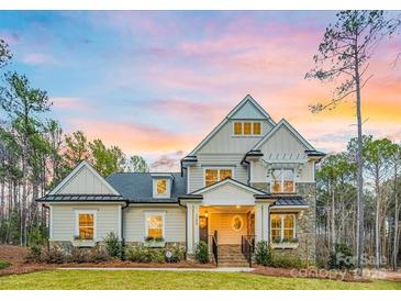 Beautiful two-story home featuring stone accents, manicured lawn, and a welcoming front porch at sunset at 3288 Sherman Dr, Lancaster, SC 29720