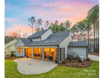 Stunning home exterior with a screened-in porch and outdoor patio, perfect for entertaining at 3288 Sherman Dr, Lancaster, SC 29720