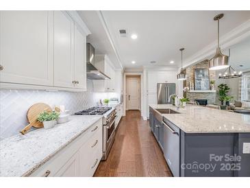 Bright kitchen with granite countertops, stainless steel appliances, and white cabinetry at 3288 Sherman Dr, Lancaster, SC 29720