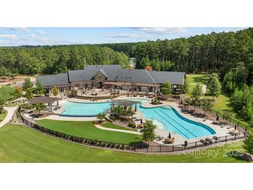 Aerial view of neighborhood pool and clubhouse surrounded by lush green landscaping at 3288 Sherman Dr, Lancaster, SC 29720