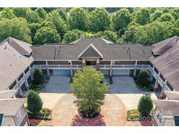 Stunning aerial view of a multi-unit property featuring a circular driveway and lush green landscaping at 8925 Rosalyn Glen Rd, Cornelius, NC 28031