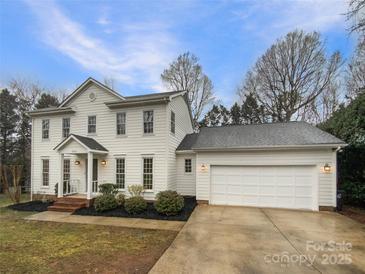 Charming two-story home features a two-car garage and manicured landscaping, enhancing curb appeal at 9105 Capsdale Ct, Huntersville, NC 28078