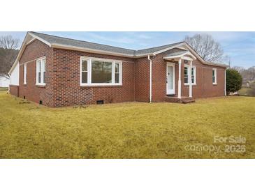 Charming brick home featuring a well-maintained lawn and inviting front entrance at 2625 20Th Ne St, Hickory, NC 28601