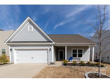 Charming single-story home with attached garage, manicured lawn, and inviting front porch at 3156 Pinehills Way, Mount Holly, NC 28120