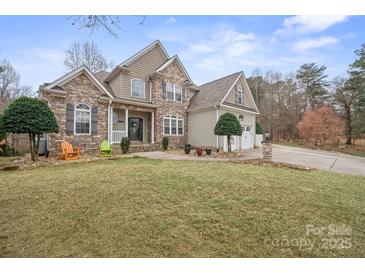 A beautifully landscaped front yard leads to this charming home with a three-car garage at 8143 Summit Ridge Dr # 41, Catawba, NC 28609