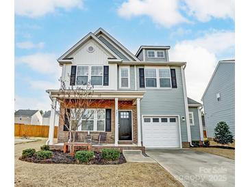 Charming two-story home with a well-manicured lawn and attached garage at 921 Von Buren Blvd, Rock Hill, SC 29730