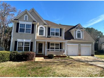 Charming two-story home featuring a welcoming front porch and a two-car garage at 8812 Glenover Cir, Charlotte, NC 28269