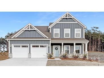Beautiful two-story home with blue siding, white trim, and a welcoming front porch at 10053 Jack Nicklaus Dr # 932, Lancaster, SC 29720