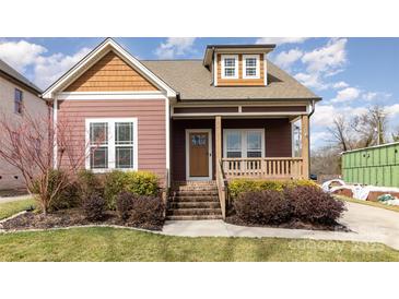 Charming home featuring a welcoming front porch with brick steps and meticulously maintained landscaping at 104 Bryant St, Belmont, NC 28012