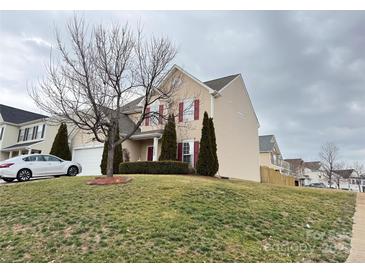 Two story home with beige siding, red shutters, and a well-maintained front yard at 14809 Castletown House Dr, Charlotte, NC 28273