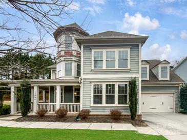 Charming two-story home featuring a welcoming front porch, attached garage, and beautifully landscaped yard at 15886 Reynolds Dr, Fort Mill, SC 29707