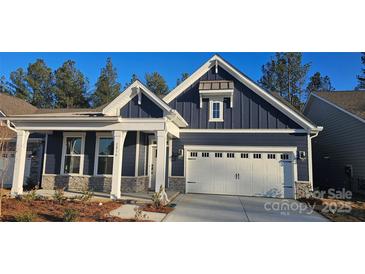 Charming home features a two-car garage, stone accents, and a covered front porch at 2016 Skyhawk Dr, Lake Wylie, SC 29745