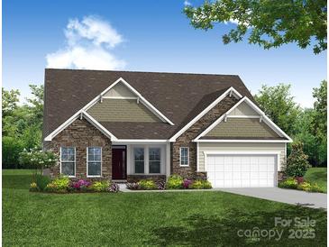 Charming home with stone and siding exterior, well-manicured lawn and beautiful landscaping at 3056 Bent Willow Dr # 175, Indian Trail, NC 28079