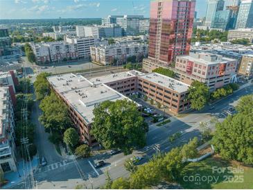 An aerial view of a charming brick building surrounded by lush trees in the heart of the city at 310 Arlington Ave # Multiple, Charlotte, NC 28203