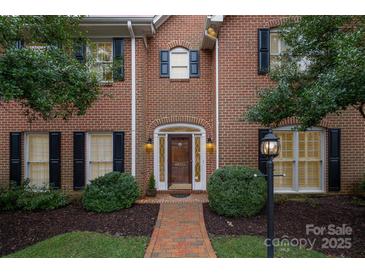 Charming two-story brick home featuring a classic design, well-maintained landscaping, and a welcoming front entrance at 4605 Curraghmore Rd, Charlotte, NC 28210