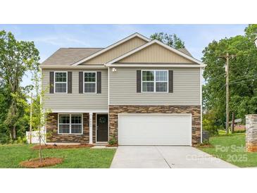 New two story home featuring stone accents, attached garage, and manicured lawn at 5050 Beargrass Dr, Dallas, NC 28034