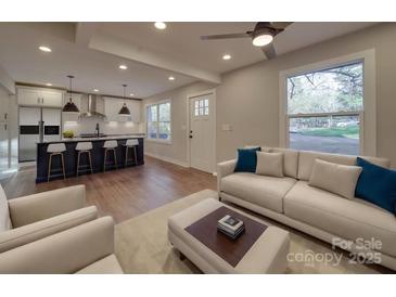 Bright, open-concept living room flows to a modern kitchen with a large island and stylish finishes at 908 Davenport St, Charlotte, NC 28208