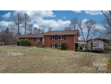 Charming two-story brick home with mature trees and a carport at 9257 Mull Rd, Vale, NC 28168