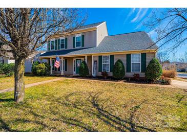 Charming two-story home with green shutters, a manicured lawn, and a welcoming front porch at 102 Brewster Ct, Mooresville, NC 28115