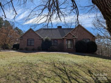 Charming brick home featuring a well-maintained lawn and mature trees at 167 Patterson Rd, Kings Mountain, NC 28086