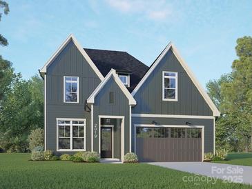 Charming two-story home featuring vertical siding, attached two car garage, and manicured lawn at 2019 Mandarin Blvd, Charlotte, NC 28205