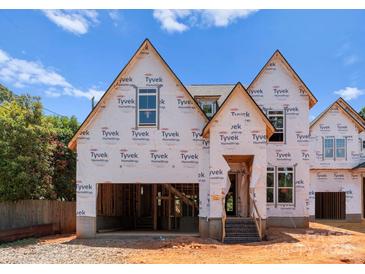 New construction home showing the frame and Tyvek wrap against blue sky at 2530 Elkwood Cir, Charlotte, NC 28205