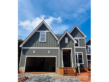New construction craftsman home featuring attached garage, board and batten siding and covered front entry at 2530 Elkwood Cir, Charlotte, NC 28205