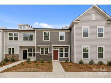 Charming townhome with stone accents, modern windows and lovely front yard at 4109 Walking Ridge Rd # 57, Charlotte, NC 28208