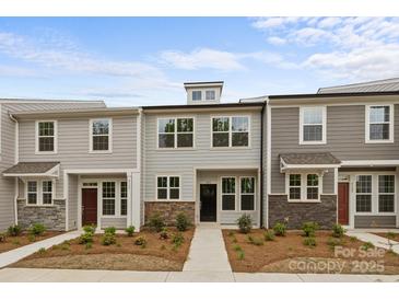 Charming townhome with stone accents and well-maintained landscaping at 4113 Walking Ridge Rd # 56, Charlotte, NC 28208
