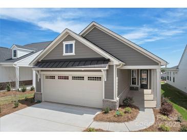 Charming gray home featuring a two-car garage and landscaped front yard at 1615 Shoals Ave # 158, Belmont, NC 28012