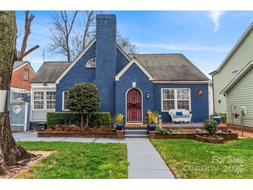 Charming blue brick home with manicured landscaping and inviting front porch at 204 Sylvania Ave, Charlotte, NC 28206