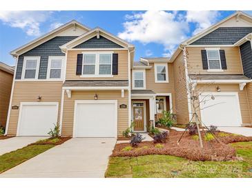 Beautiful townhome with a well-manicured lawn, two-car garage, and attractive curb appeal at 2280 Hedgecliff Rd, Kannapolis, NC 28025