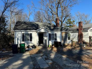 Charming one-story home featuring a classic design, inviting entrance, and a well-manicured lawn at 2404 Booker Ave, Charlotte, NC 28216