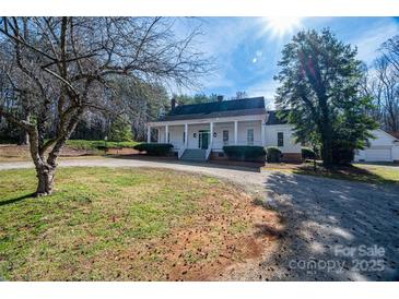 Charming white home with inviting front porch and mature landscaping at 246 Jerry Crump Rd, Lincolnton, NC 28092