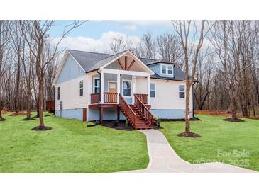 Charming home showcasing a welcoming front porch and manicured lawn at 2855 W Zion Church Rd, Shelby, NC 28150