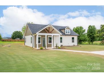 Charming home featuring a covered porch, manicured lawn, and eye-catching exterior color scheme at 2867 W Zion Church Rd, Shelby, NC 28150